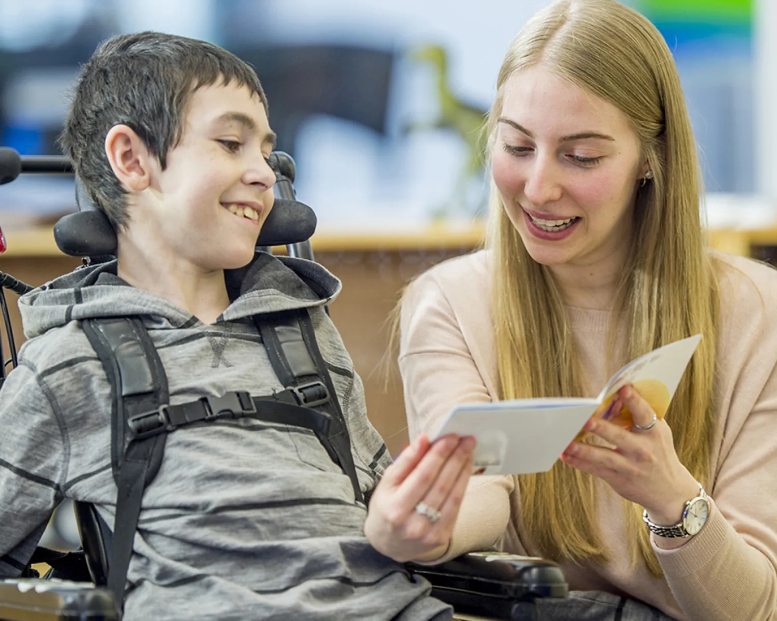 teacher reading to student in wheelchair
